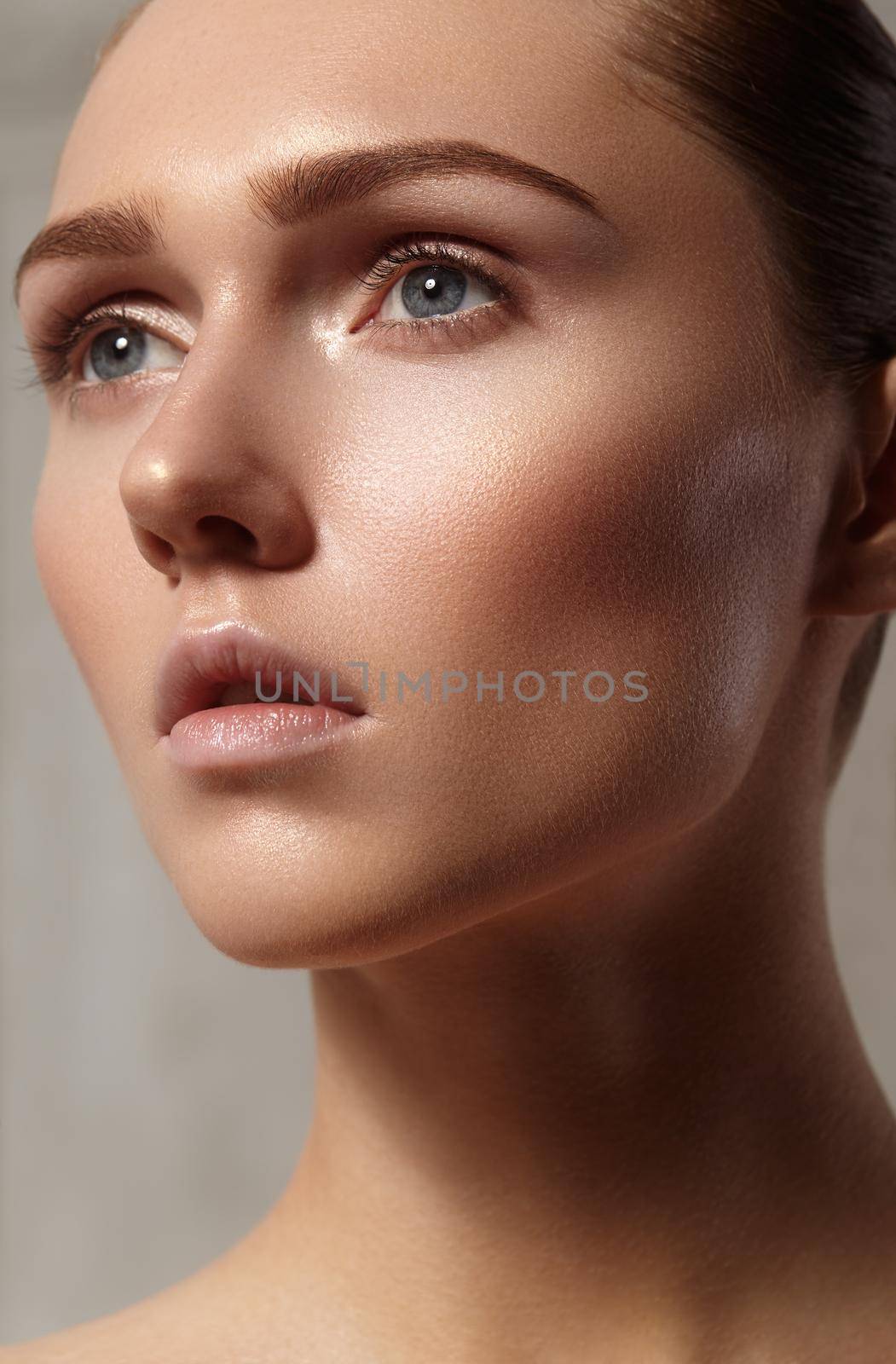 Beautiful young woman with perfect clean shiny skin, natural fashion makeup. Close-up woman, fresh spa look. Healthy beauty