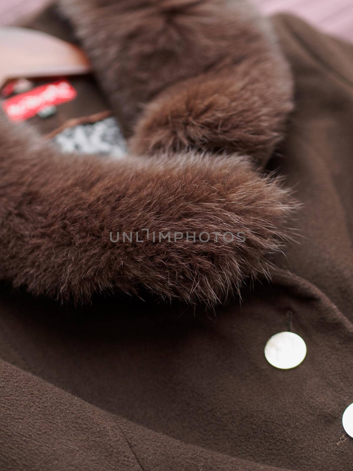 Close up of fashionable mens brown coat combined with brown fashionable sweater. Low DOF.