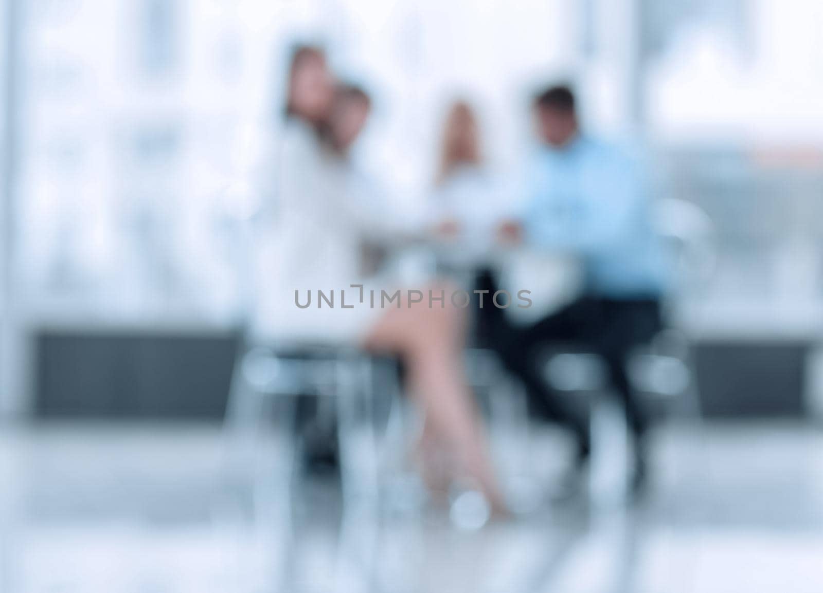 abstract blurred group of business people sitting at a table by asdf
