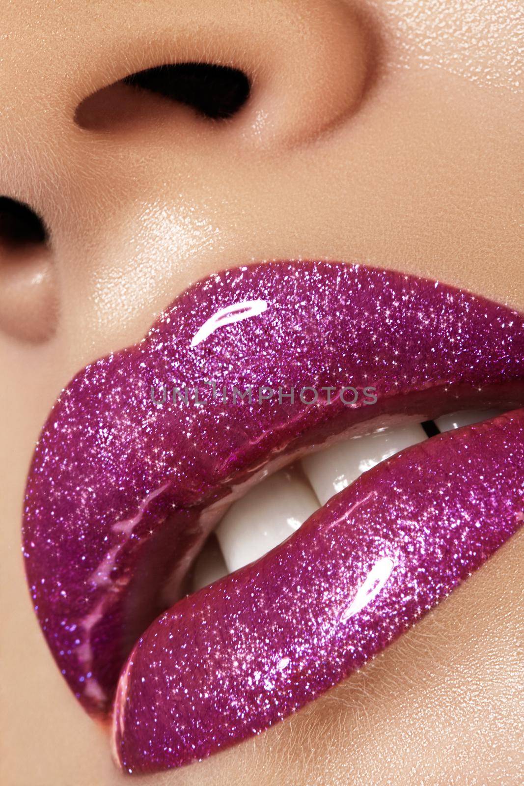 Glamour magenta gloss lip make-up. Fashion makeup beauty shot. Close-up female sexy full lips with celebrate pink gloss lipstick