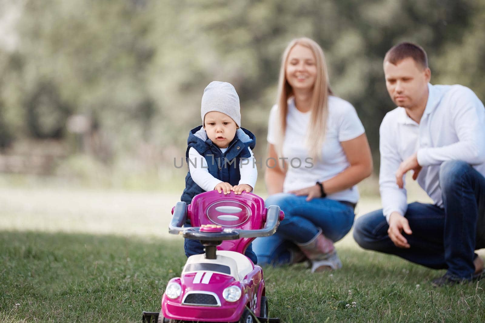 little boy on a walk with his parents. photo with space for text