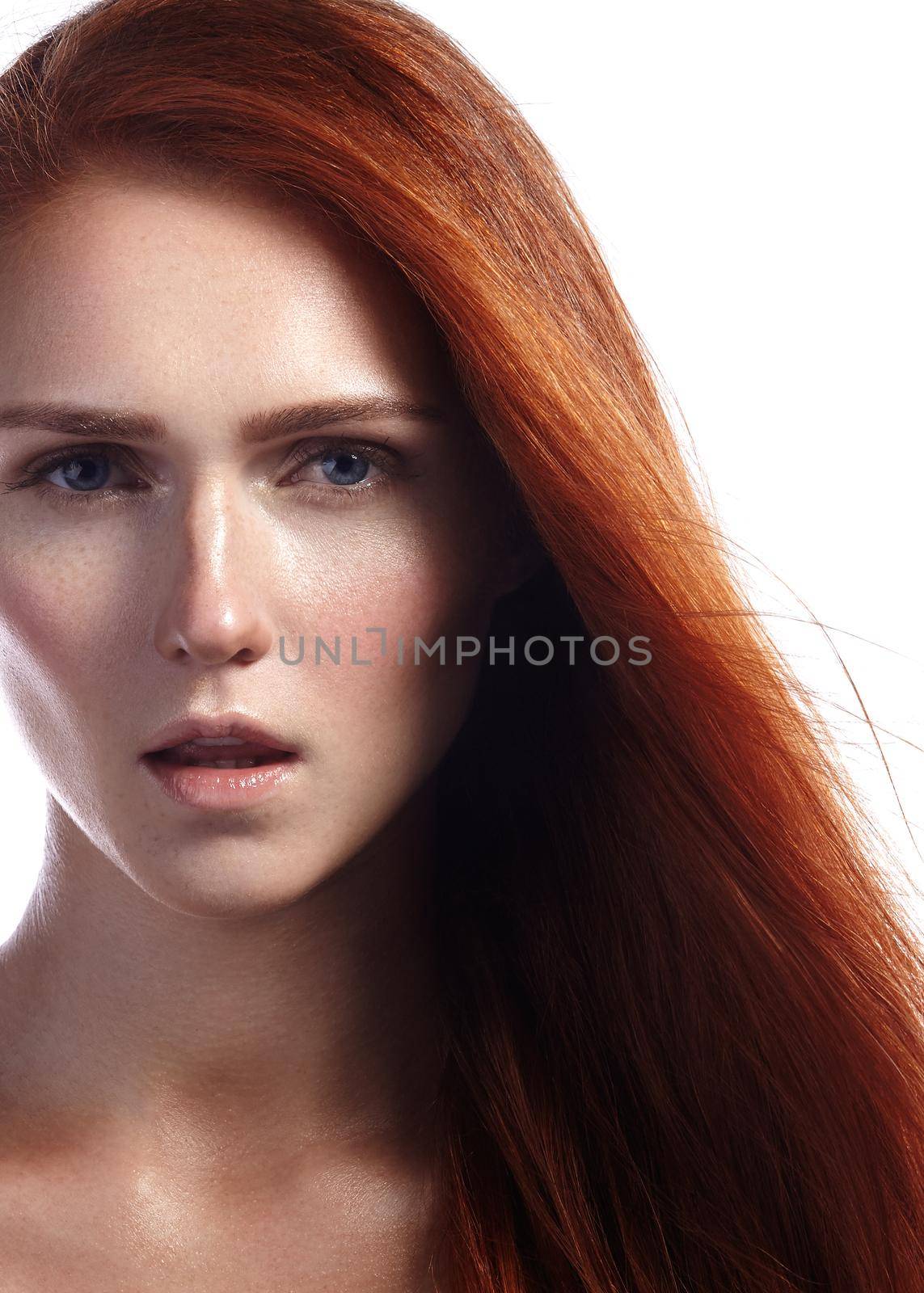 Beautiful ginger young woman with flying hair and naturel makeup. Beauty portrait of sexy model with straight red hair. Long soft shiny hairstyle. Close-up studio shot o fashion look redhead girl