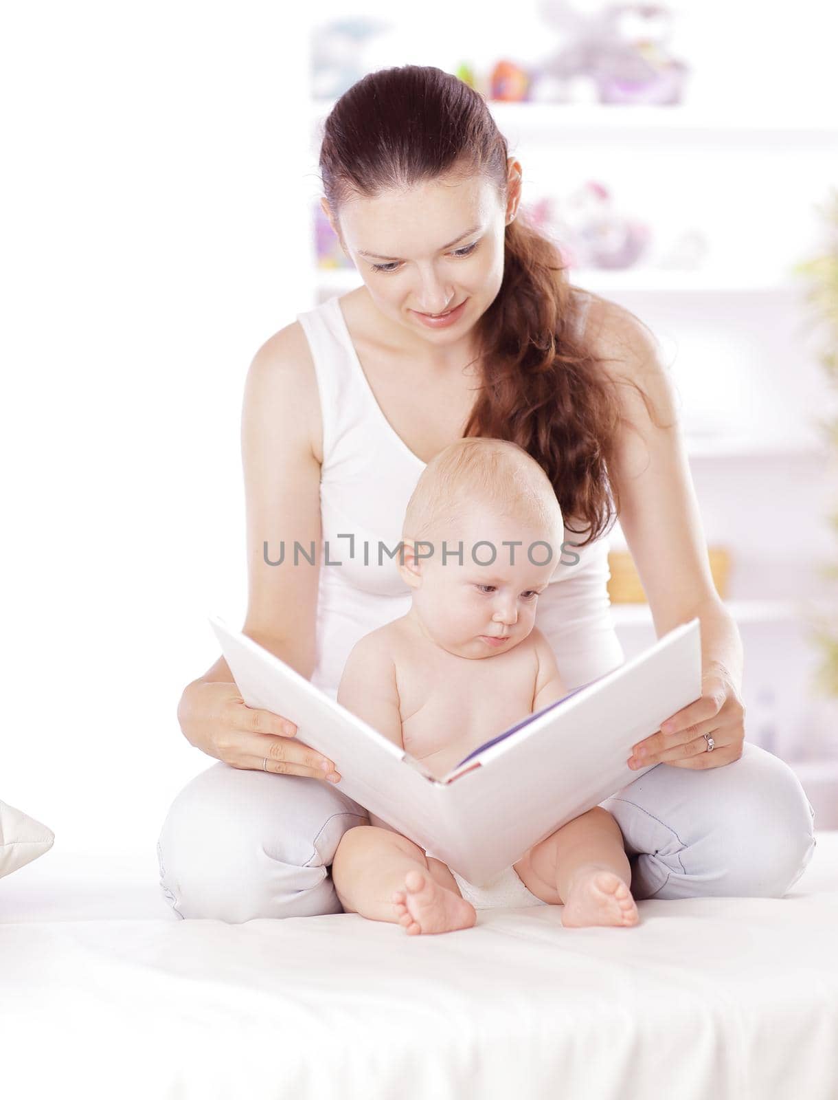 charming mom reading a book to her baby by SmartPhotoLab