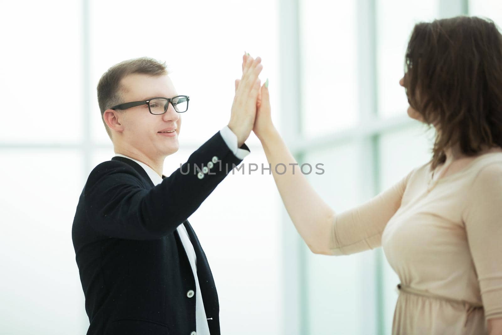 young business partners giving each other high five. the concept of a startup