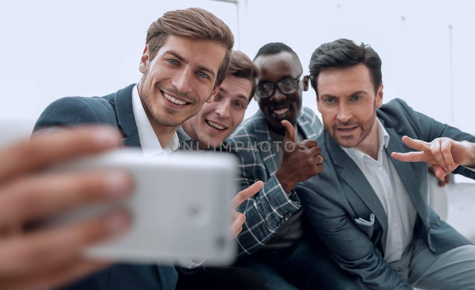close up.a group of young employees takes a selfie by asdf