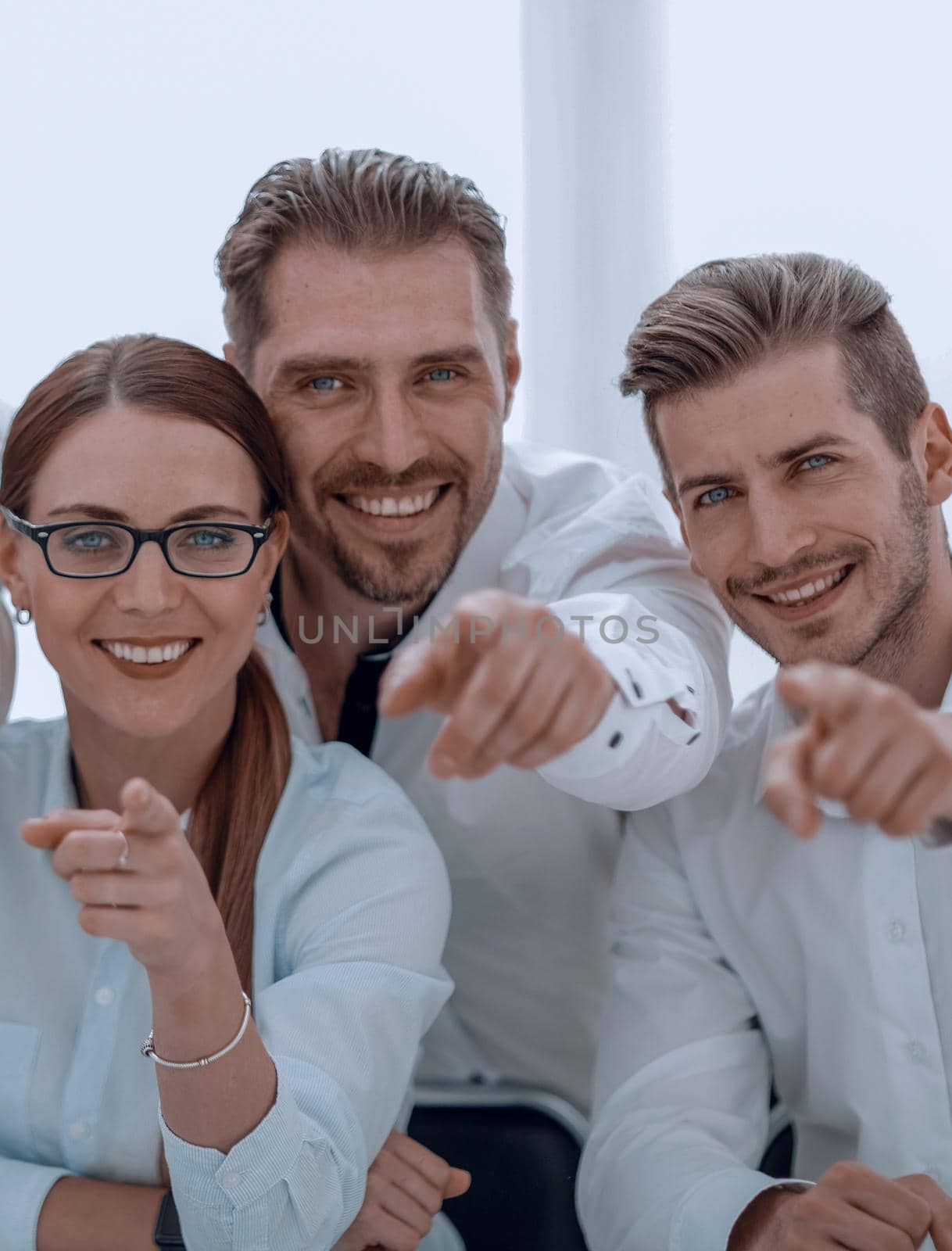 smiling business team pointing at you.the concept of choice