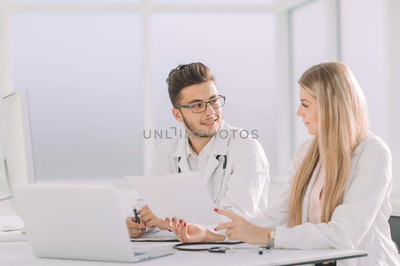 doctors colleagues talking sitting at a table in the office.photo with copy space