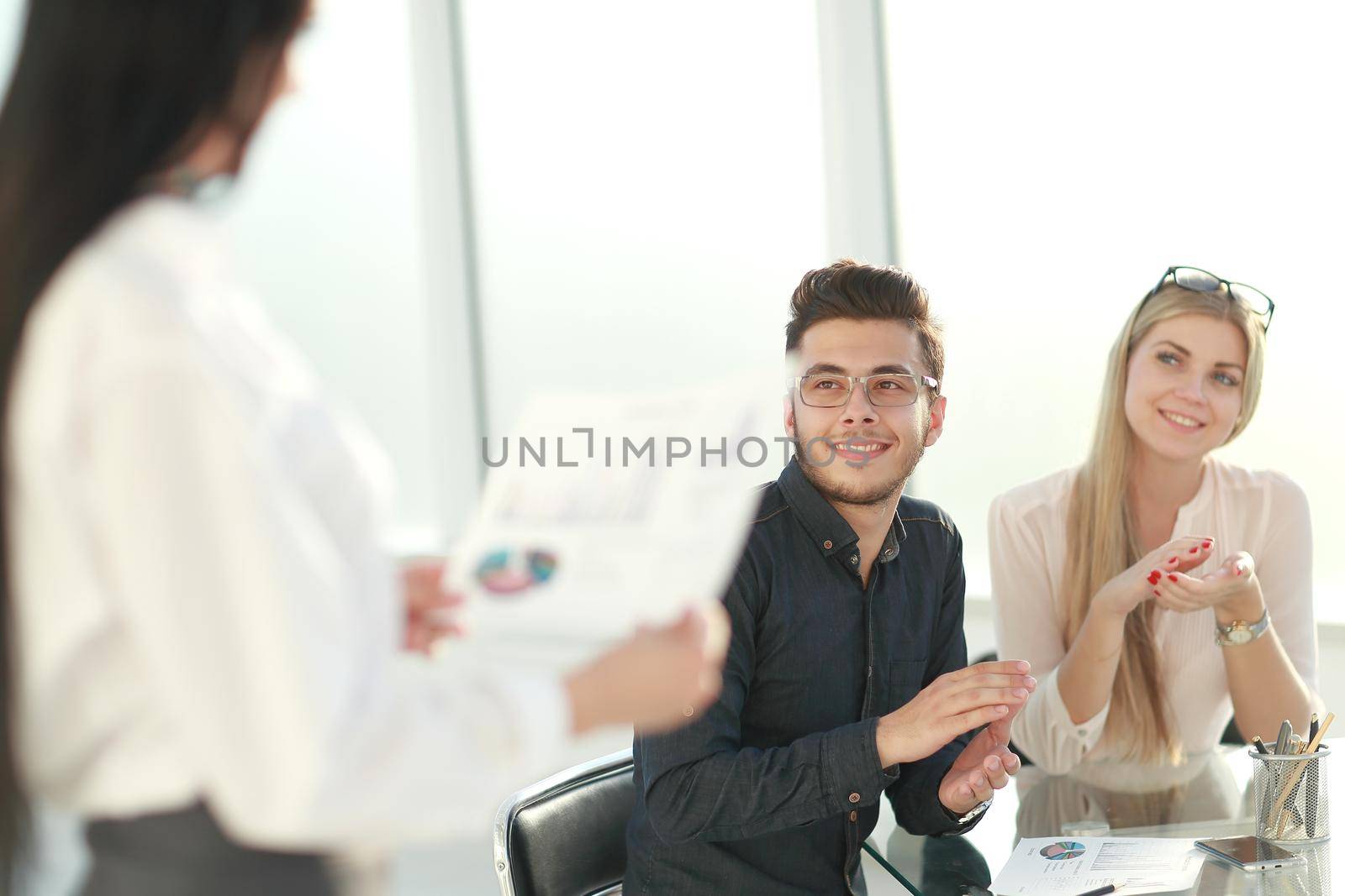 employees applauded at a business meeting in the office. business concept