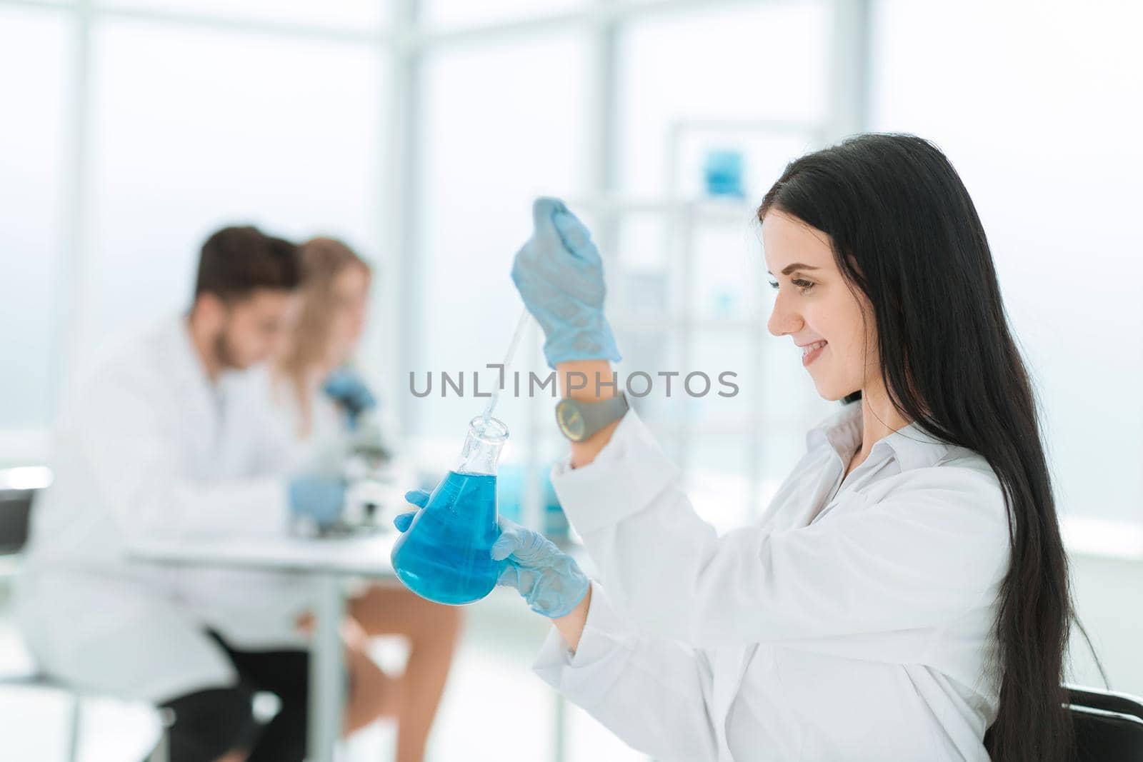 close up.female laboratory assistant takes a sample of the liquid . photo with copy space