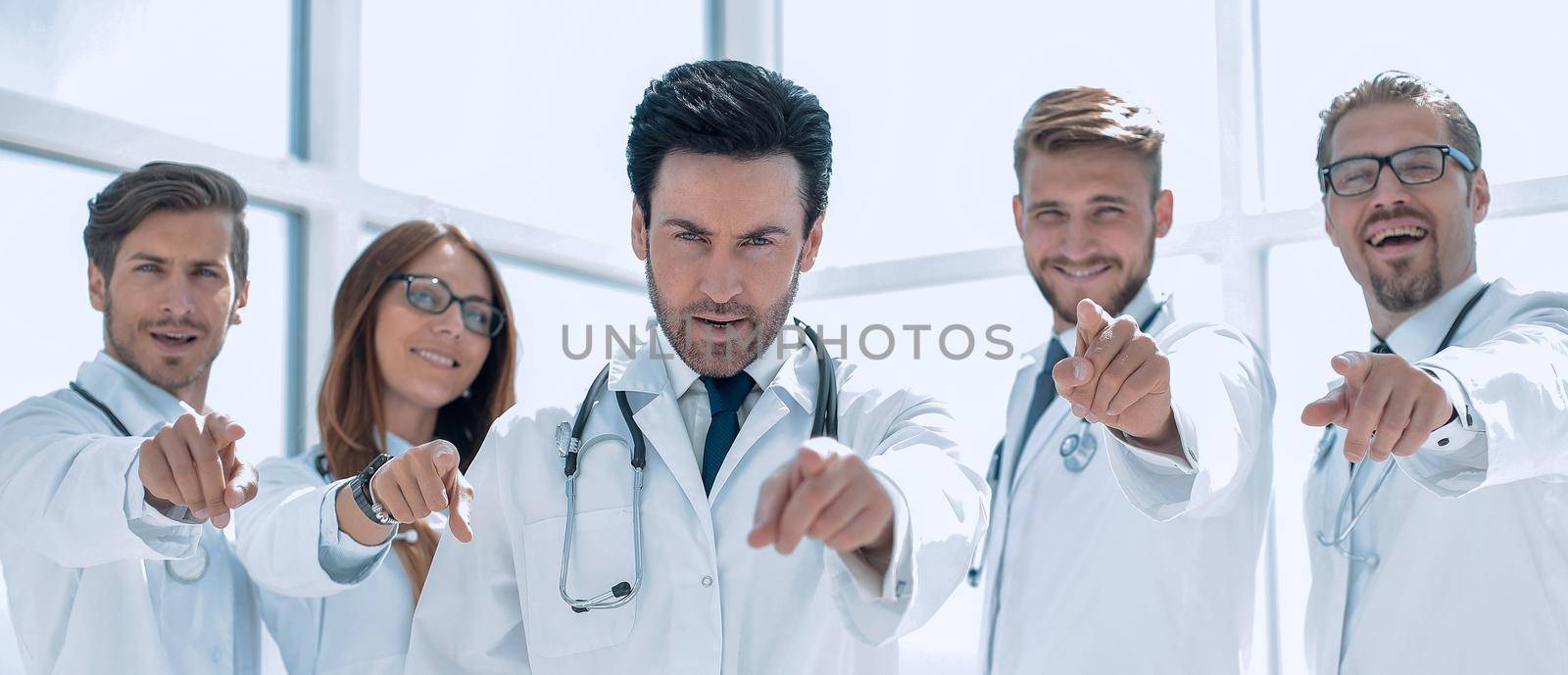 group of confident doctors pointing their finger at you.the concept of health