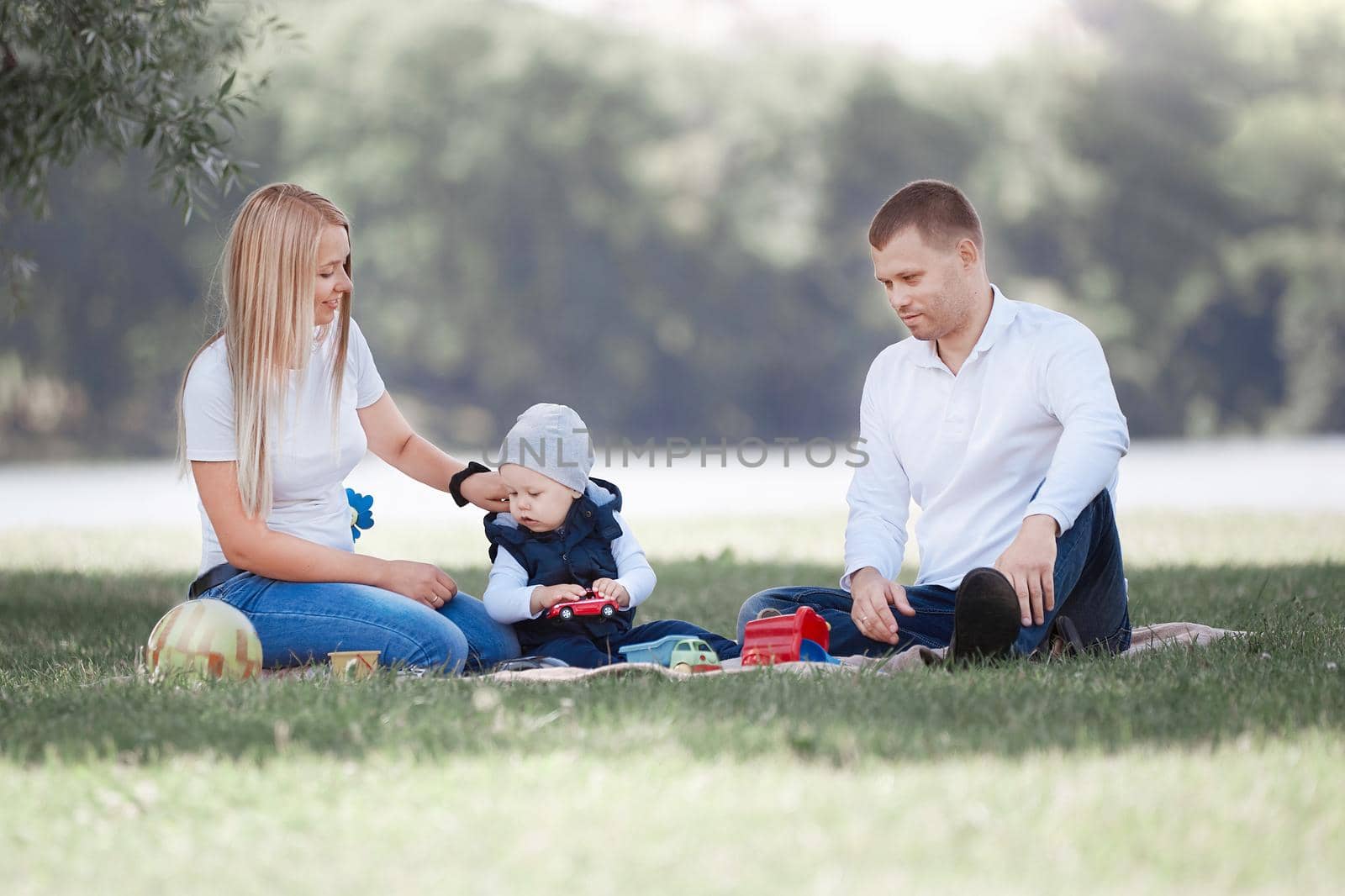 loving parents and their little son have fun together. by SmartPhotoLab
