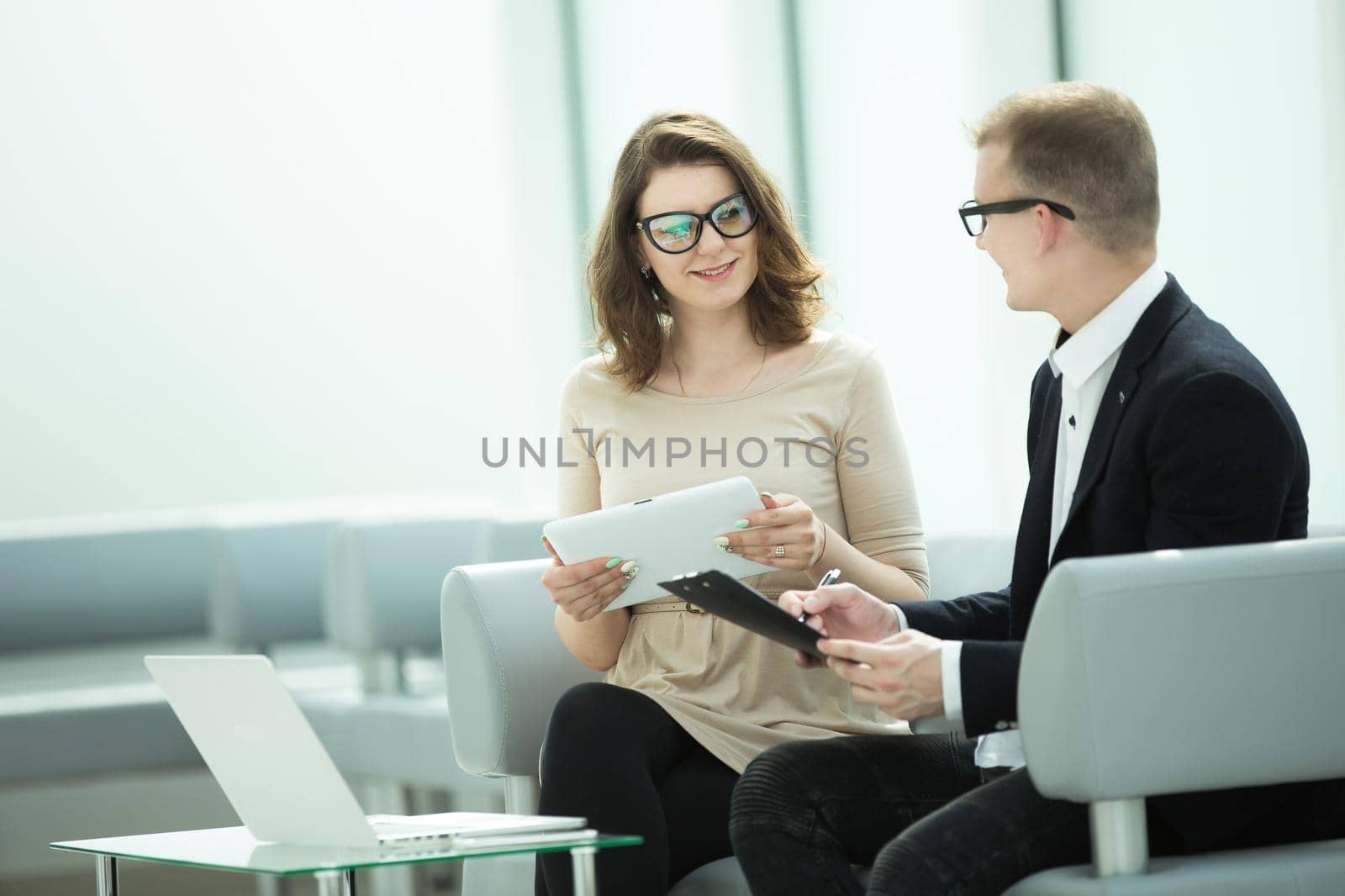 businessman and business woman discussing business documents by SmartPhotoLab