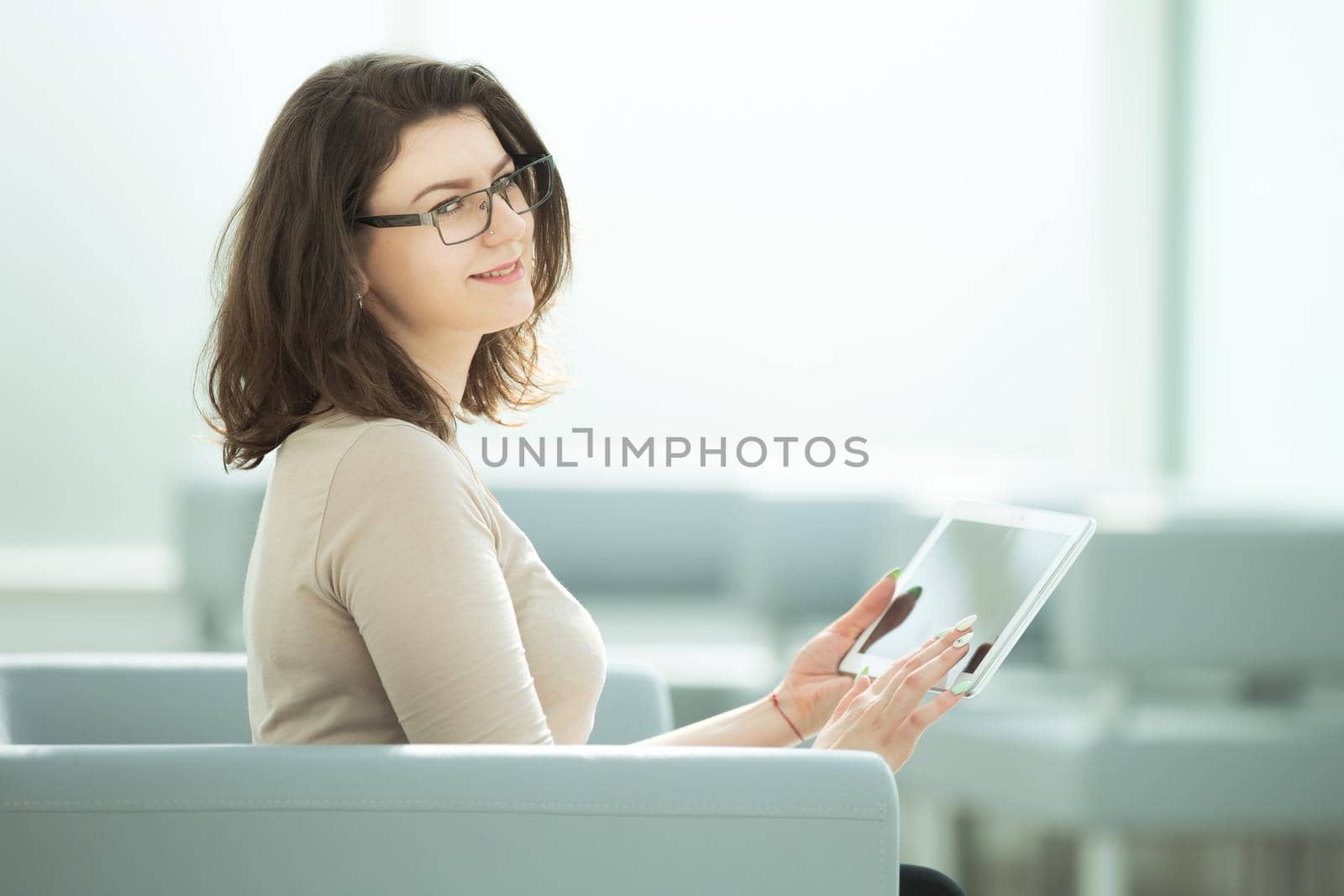 businesswoman uses a digital tablet, sitting in the office room .photo with copy space