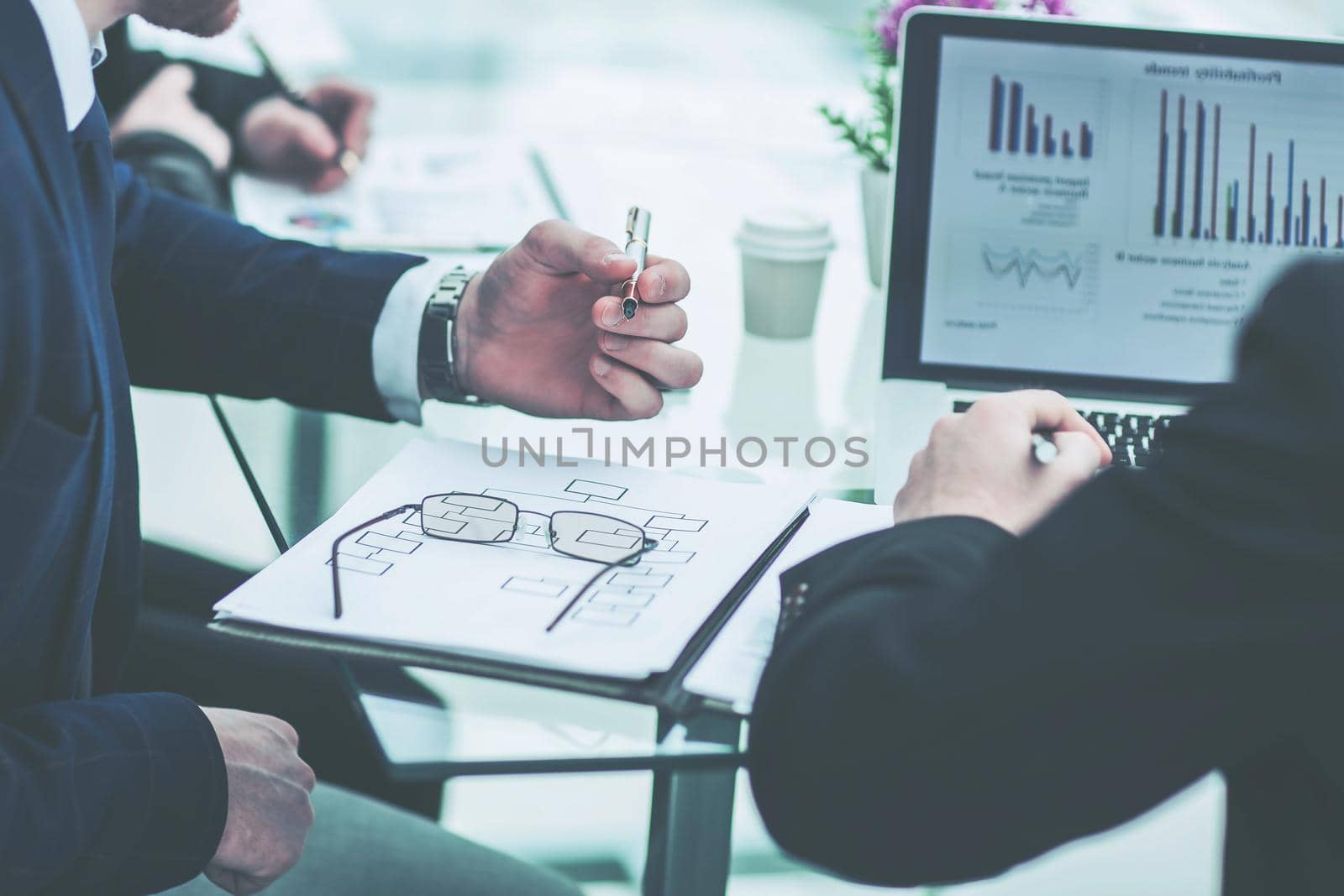 business team discussing financial charts the company's developm by SmartPhotoLab