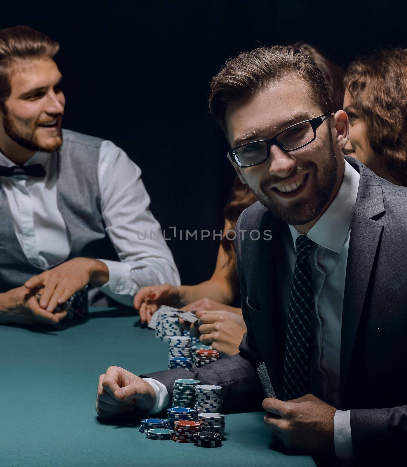 modern businessman playing poker in the night club