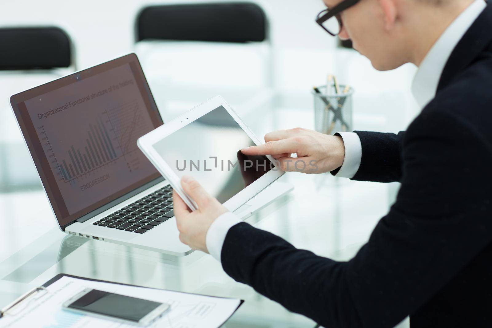 close up.businessman with a digital tablet in the workplace. people and technology