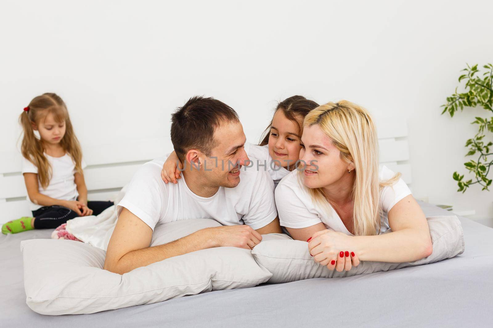 A young family with young children to bed in the bedroom.