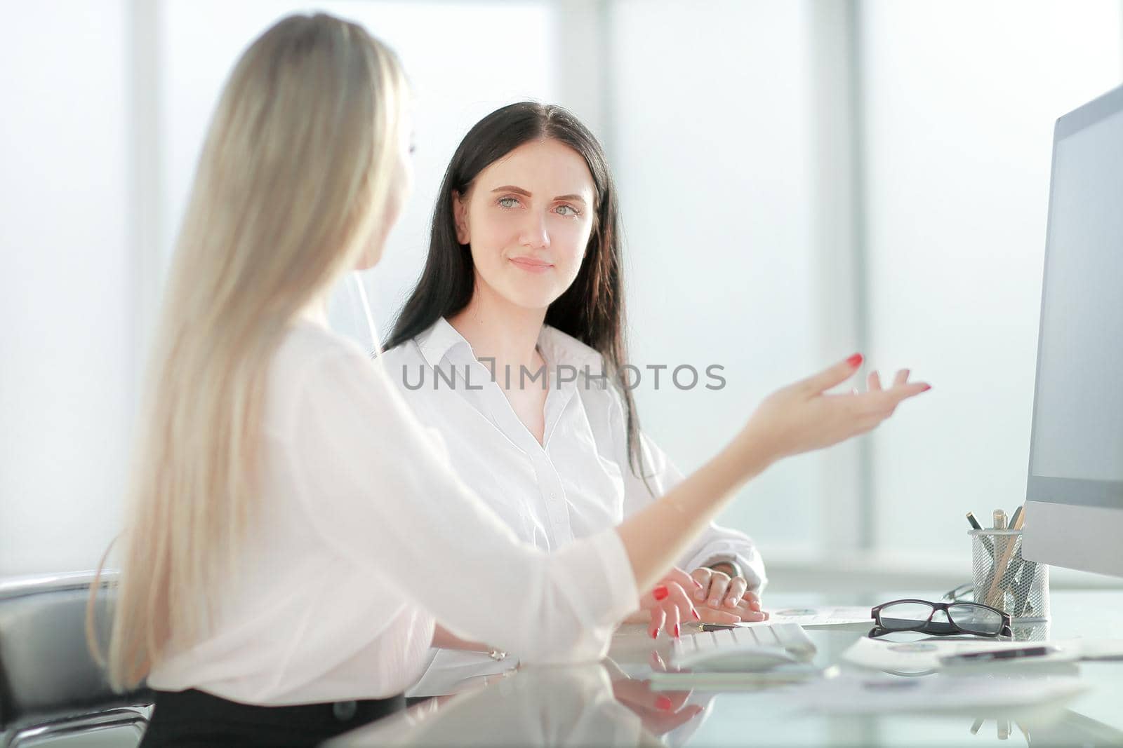 two employees sitting at the office Desk. office weekdays