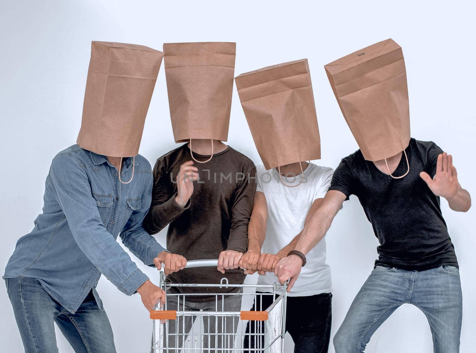 men with paper bags on head and shopping cart in hands on isolated background