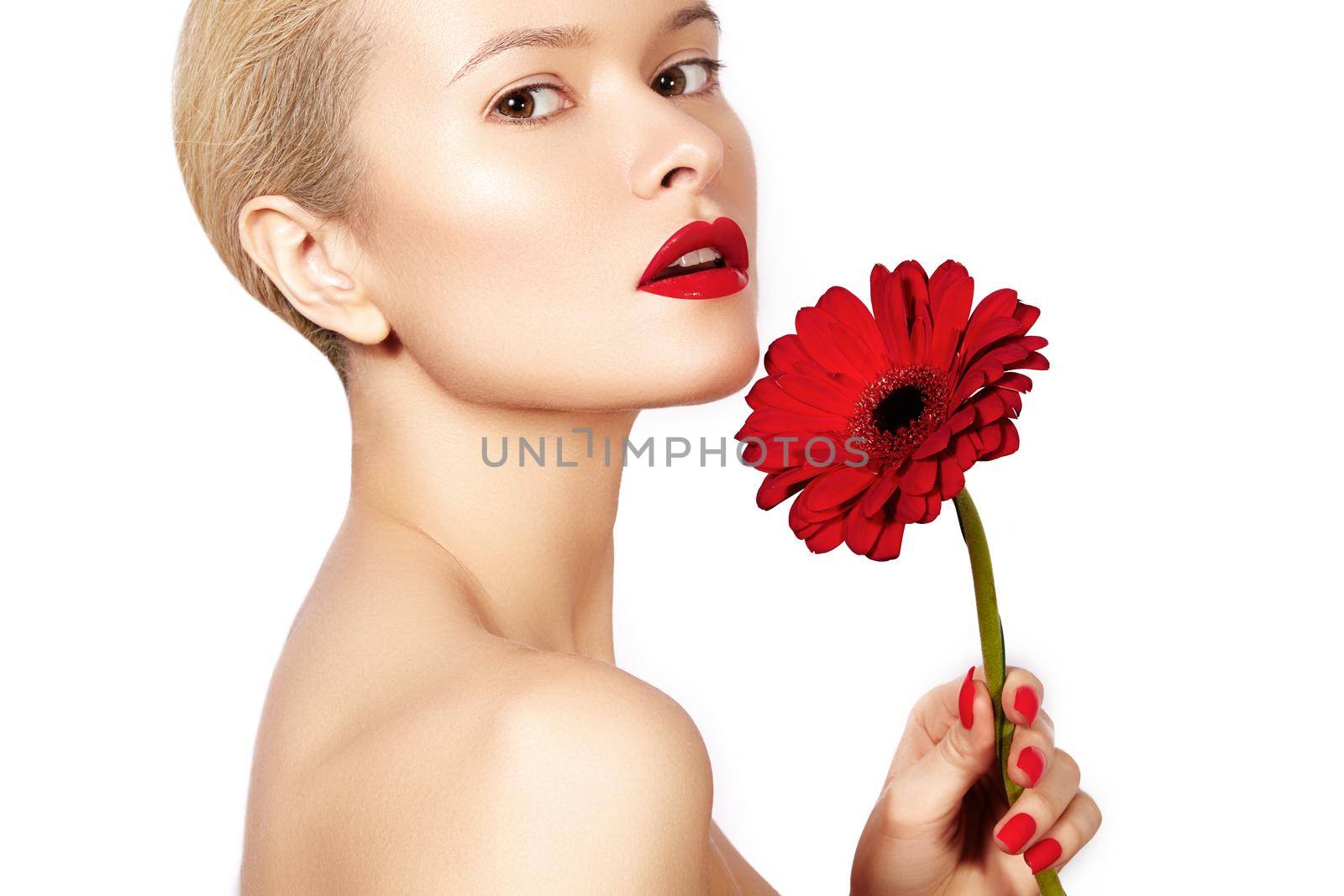 Close-up beauty photo sexy woman with red lips, lipstick and beautiful red flower. Spa portrait female face with clean skin