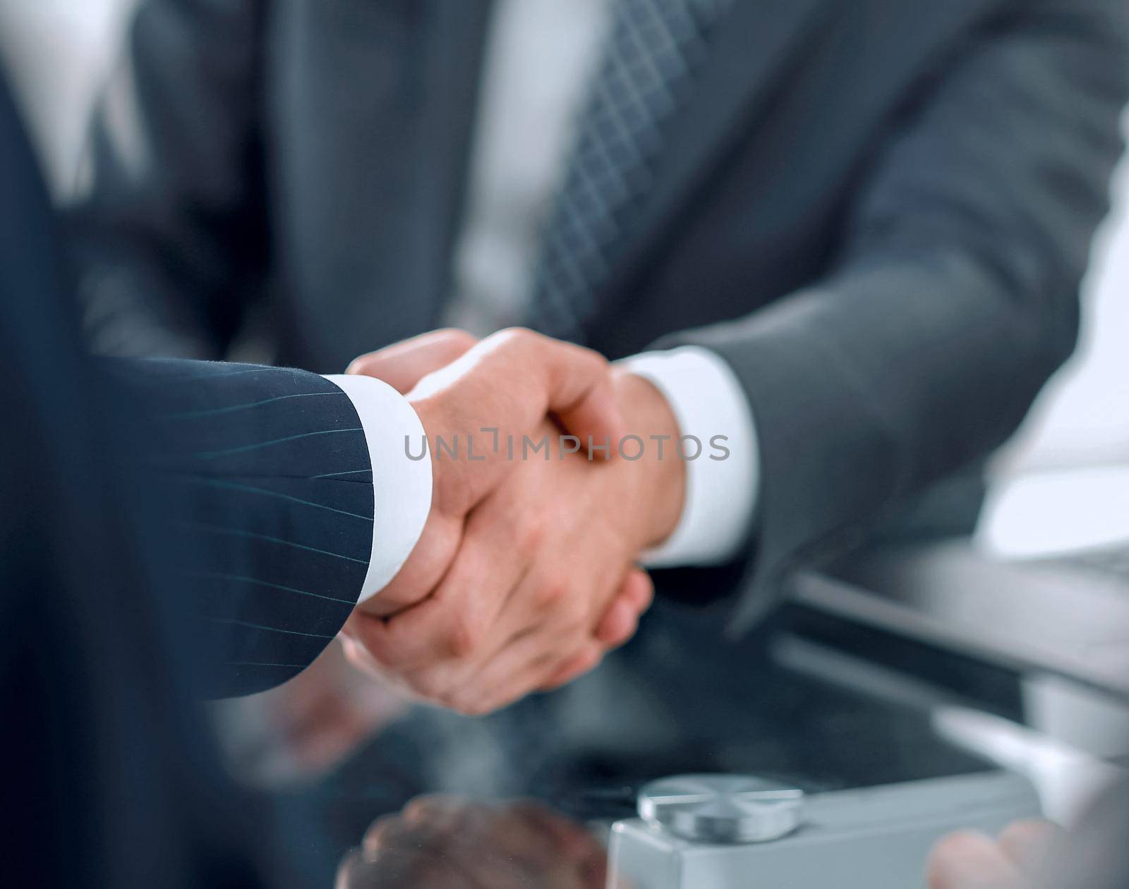 closeup.handshake of business partners after signing the contract.