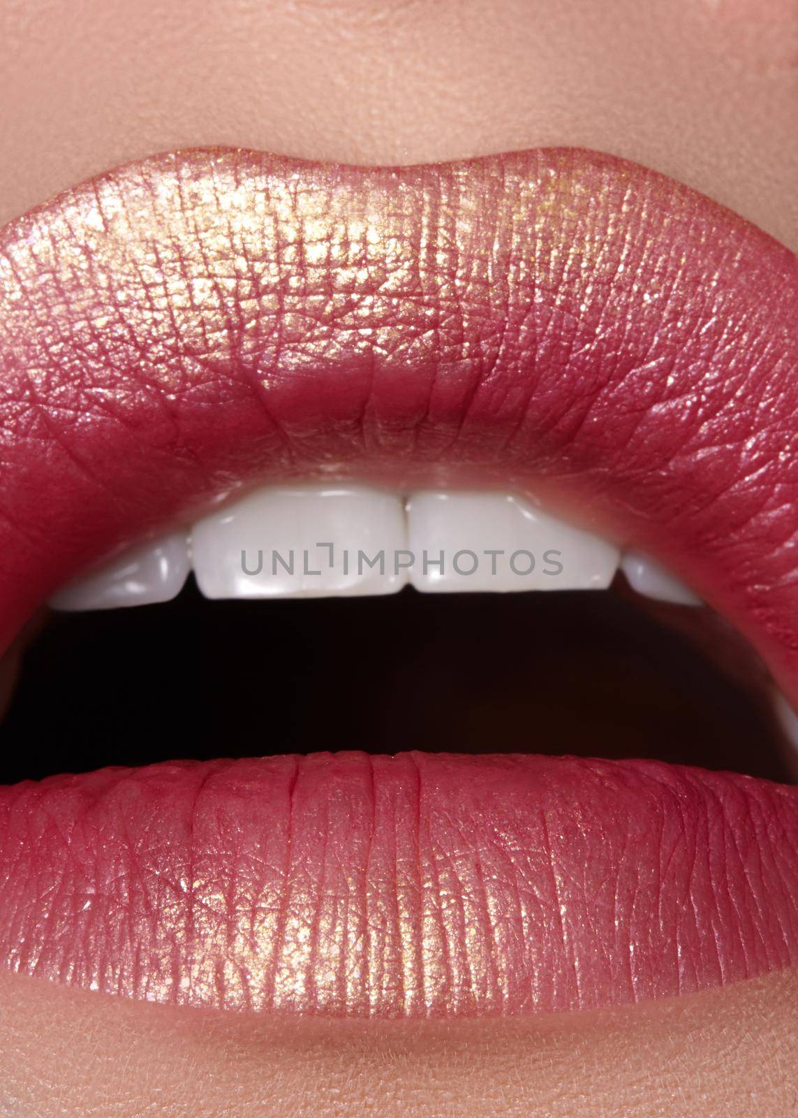 Macro close-up glamour fashion bright red lips make-up with gold glitter. Macro of woman's face part. Sexy lip makeup, luxury visage