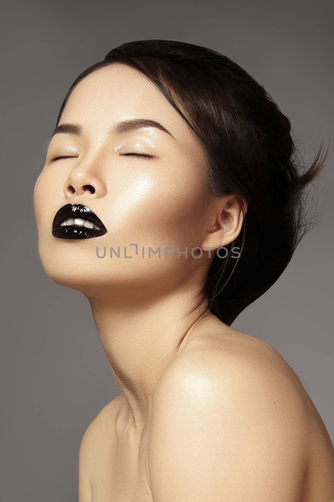 Perfect asian model with fashion make-up and hairstyle. Beauty halloween style with black lips makeup. Catwalk visage, dark hair style