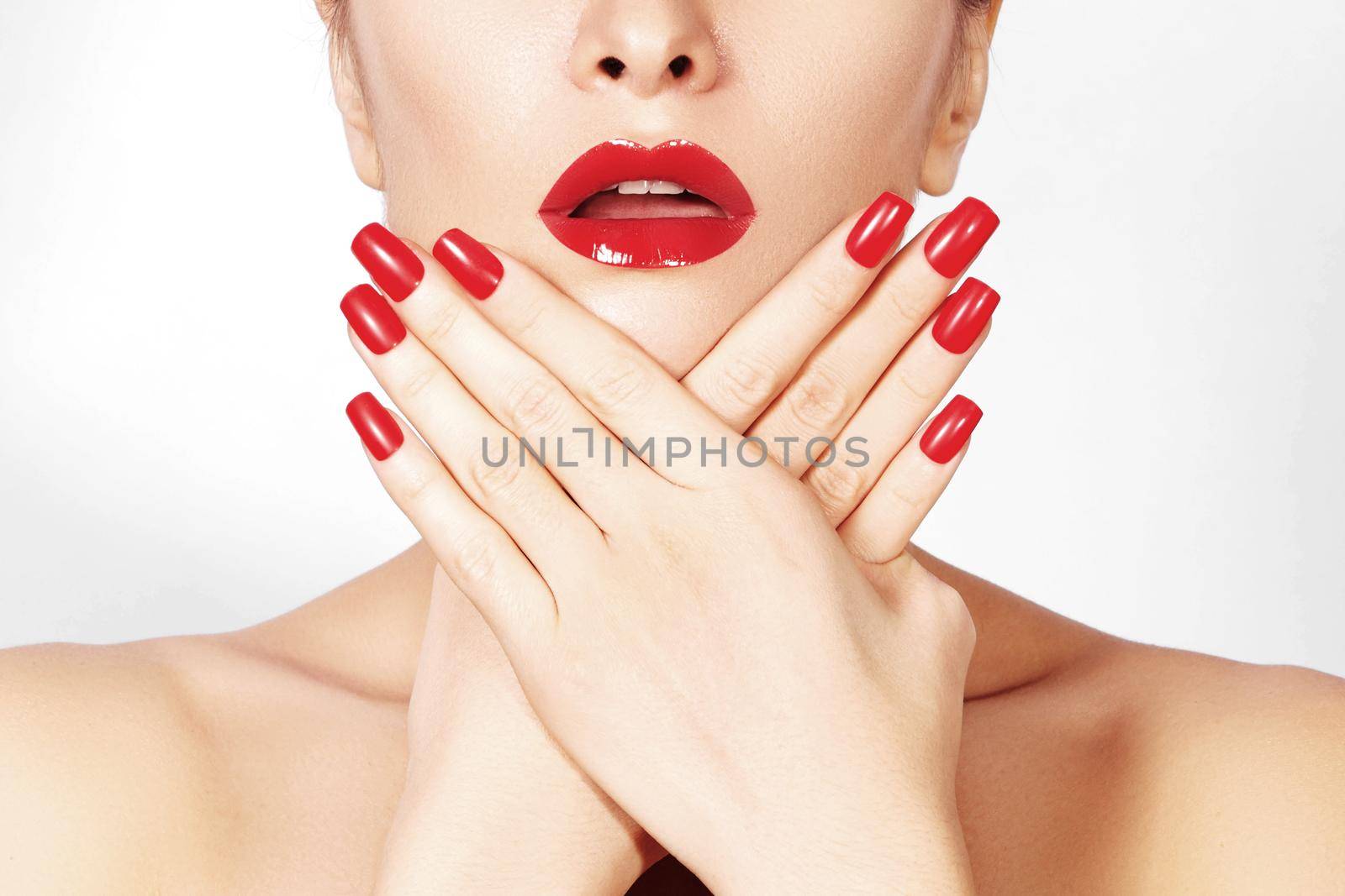 Red lips and bright manicured nails. Sexy open mouth. Beautiful manicure and makeup. Celebrate make up and clean skin. Kiss