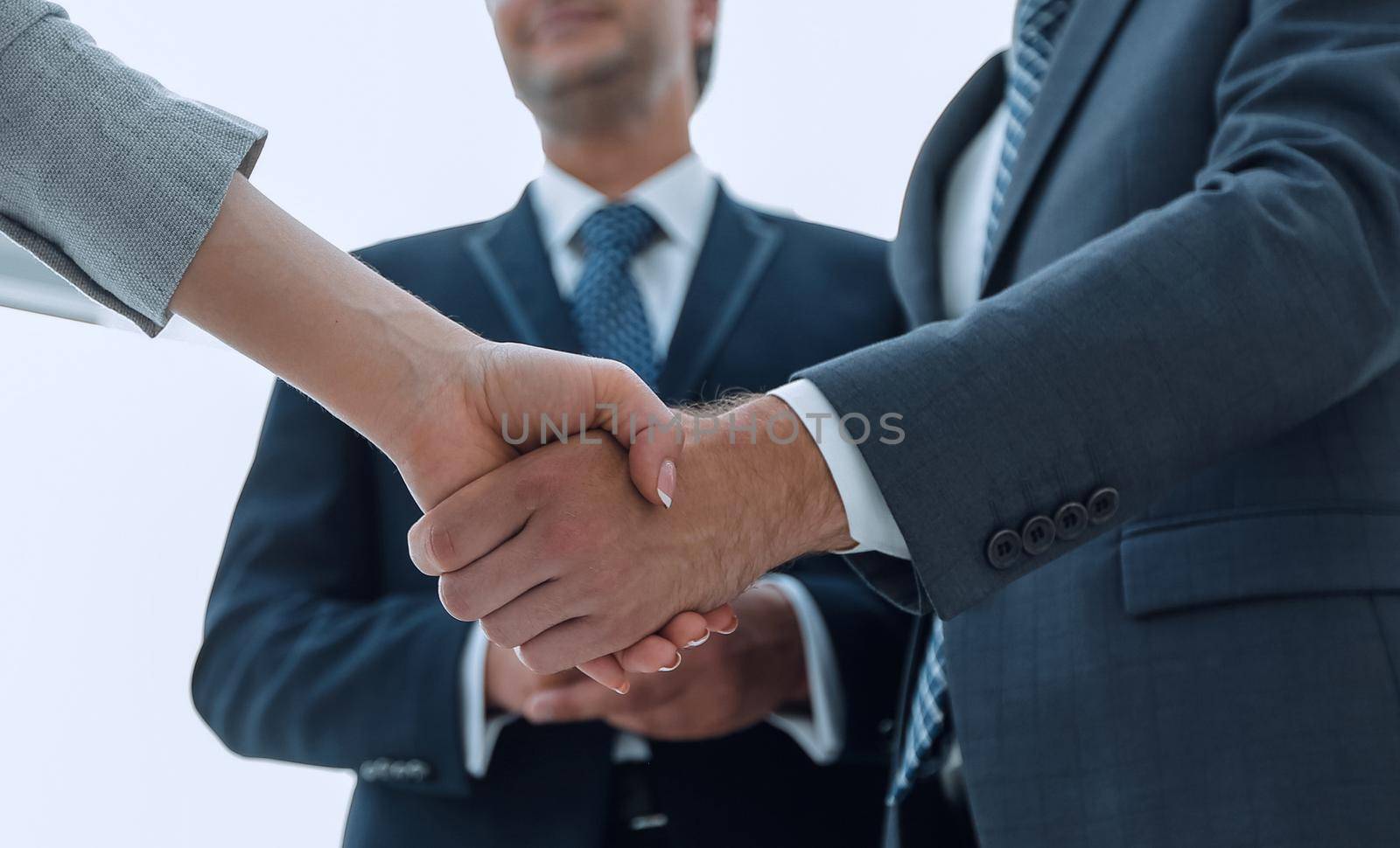 Close-up of business people shaking hands by asdf