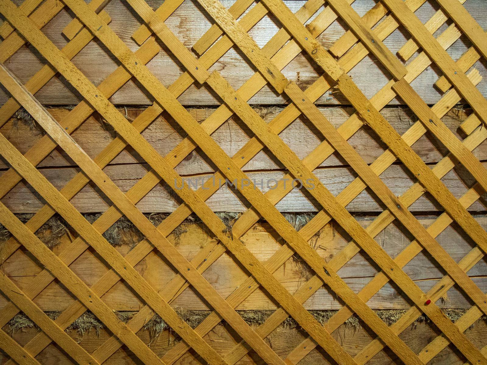 Old wooden wall of an old house in lattice pattern with rough texture. by Andre1ns