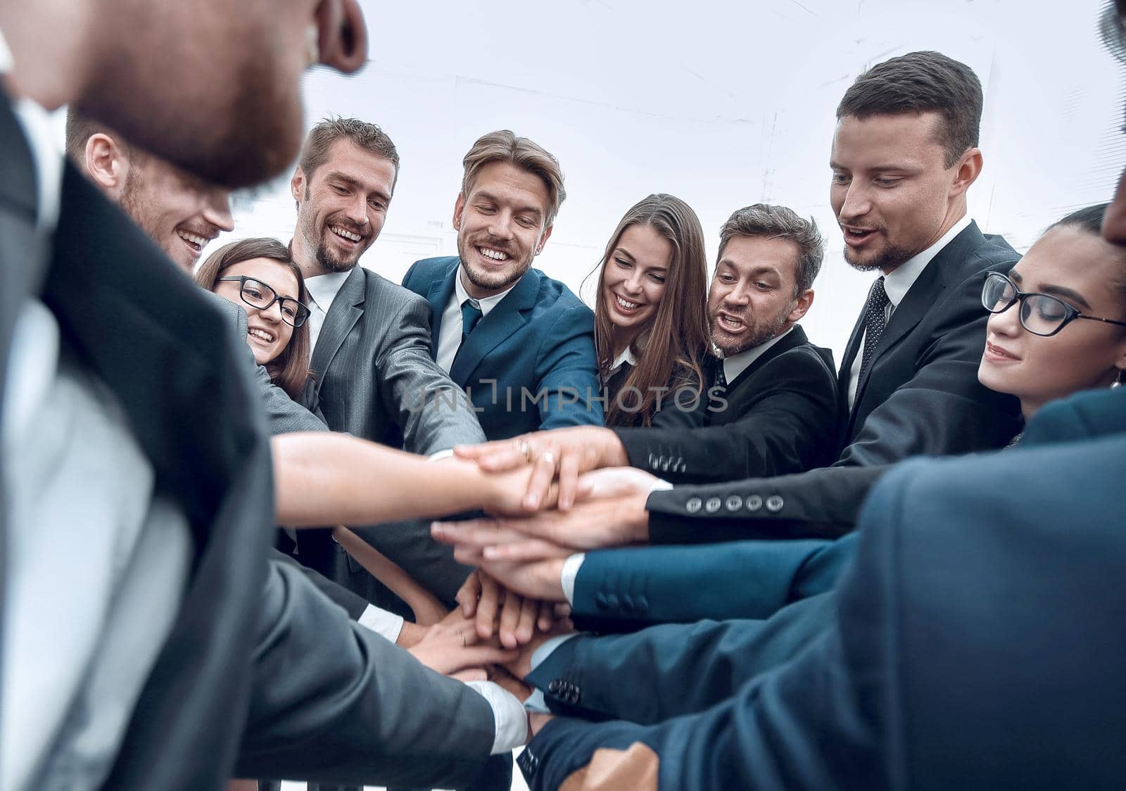 large group of business people standing with folded hands together by asdf