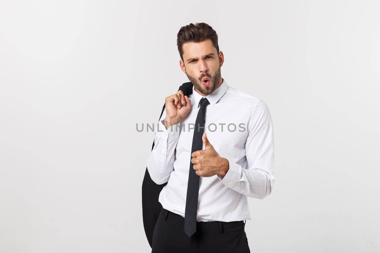 Portrait of confident handsome man holding his suit, isolated on white background.