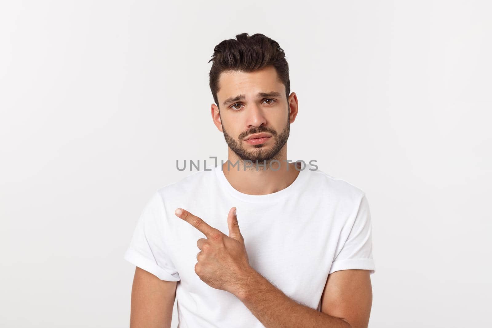 Close up portrait of disappointed stressed bearded young man in shirt over white background. by Benzoix