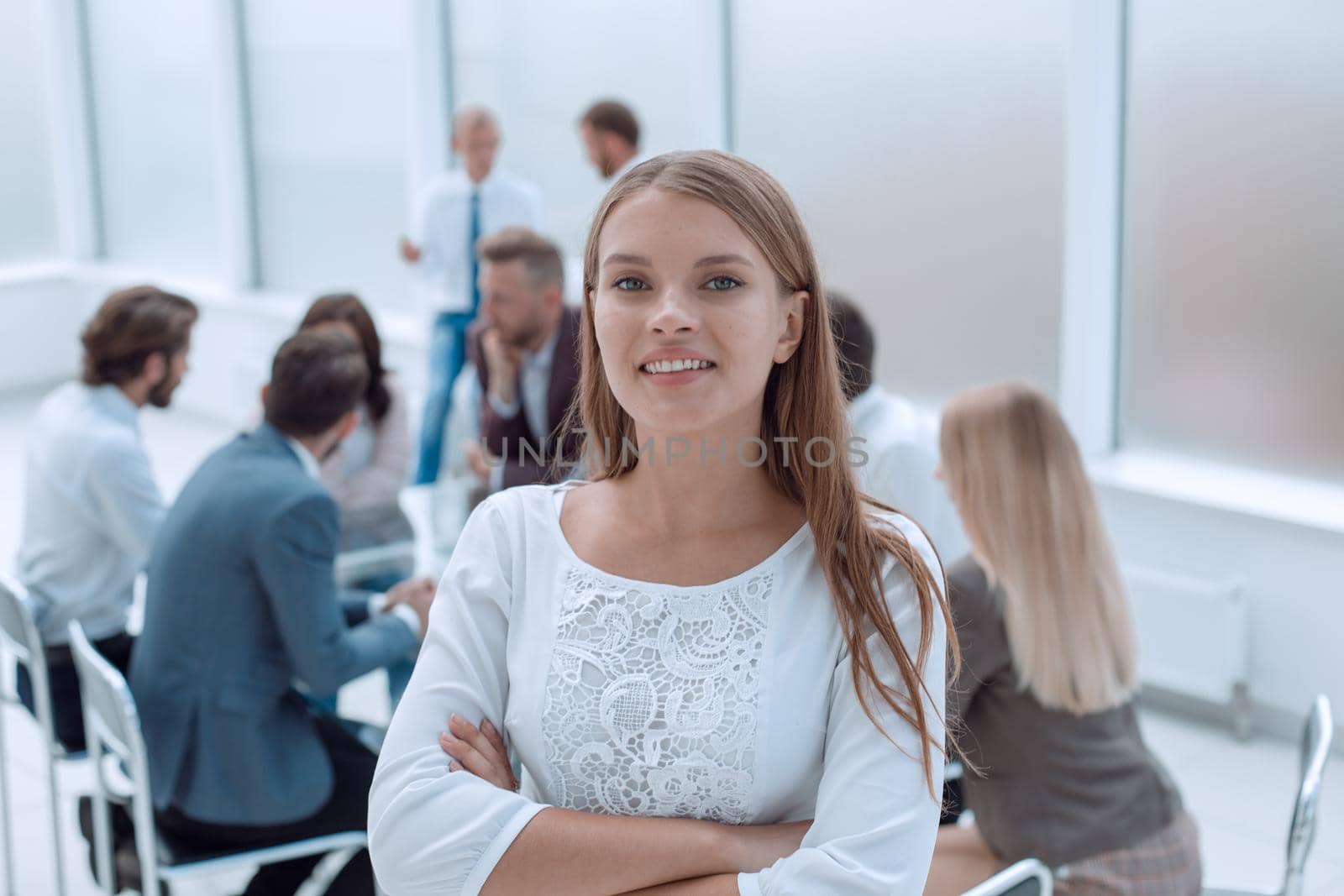 smiling young employee standing in business office. business concept