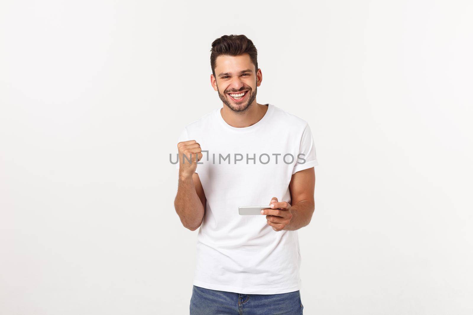 portrait of a young man playing video games on mobile phone on gray background. by Benzoix