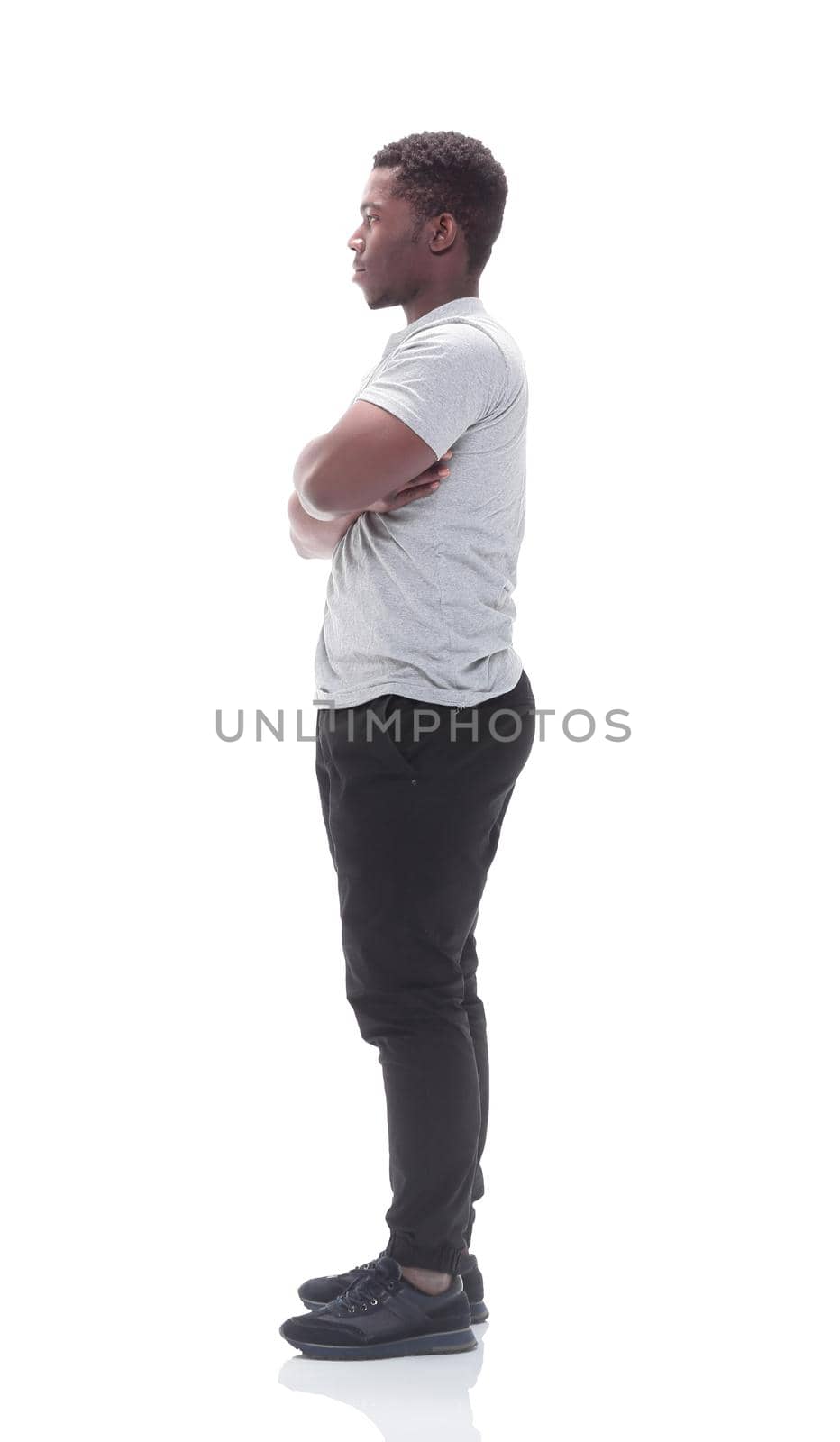 side view. smiling guy in a white t-shirt. isolated on white background