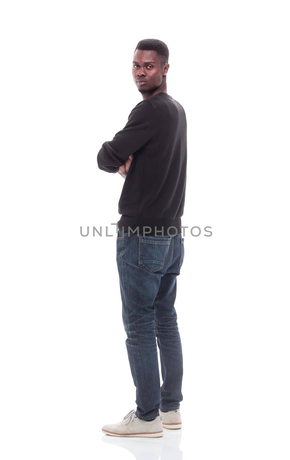 side view. casual young man looking forward . isolated on white