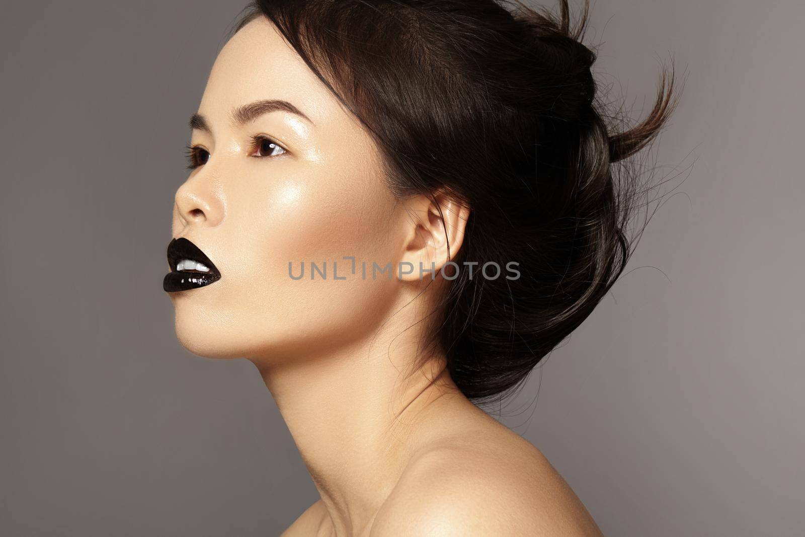 Perfect asian model with fashion make-up and hairstyle. Beauty halloween style with black lips makeup. Catwalk visage, dark hair style