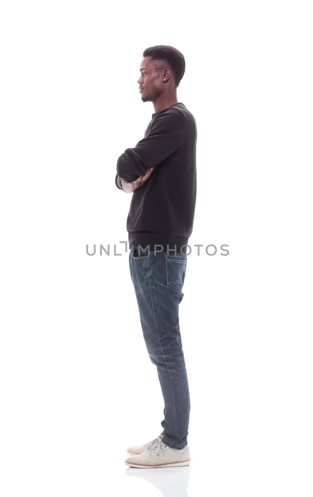 side view. casual young man looking forward . isolated on white