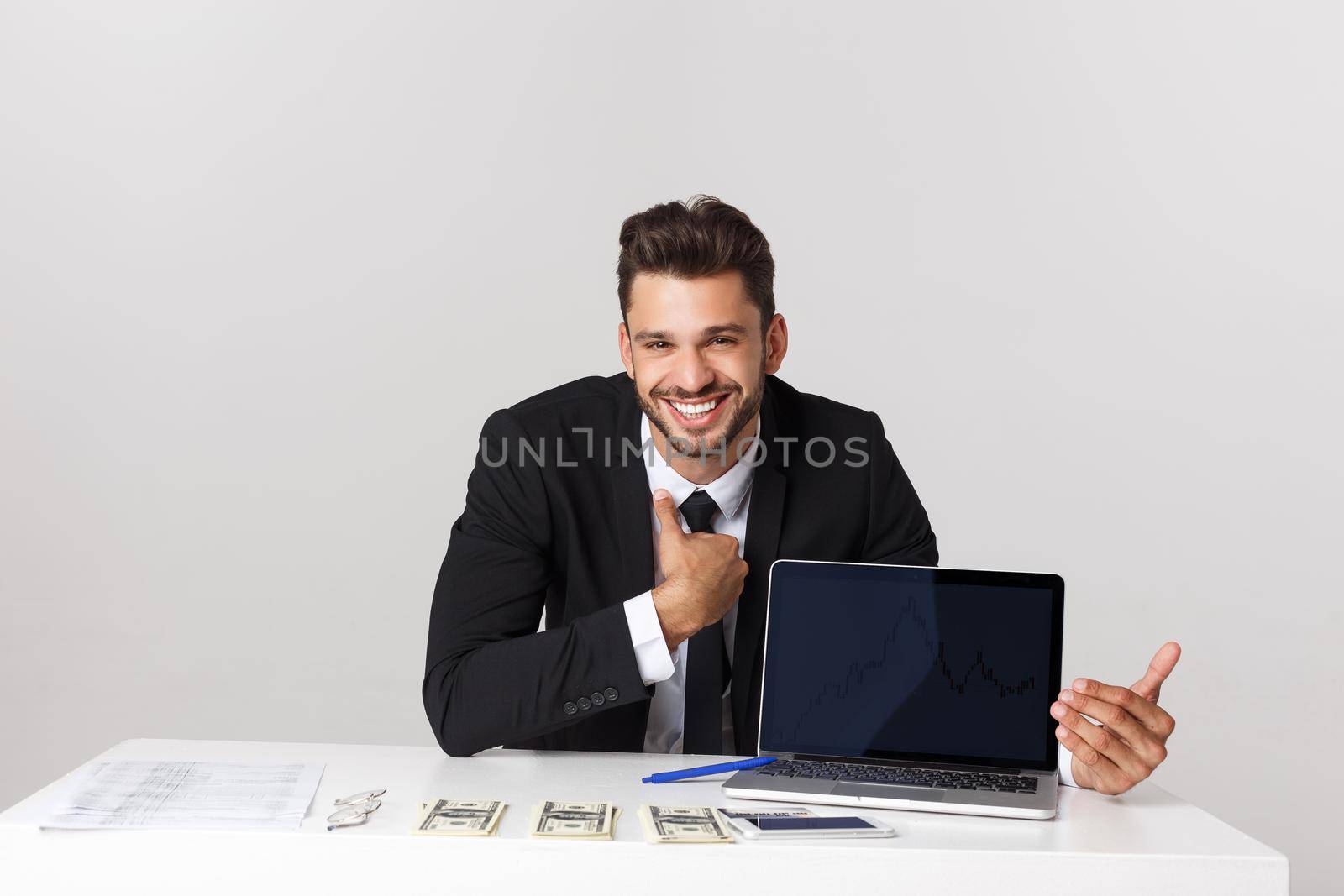 businessman sitting at desk point finger at isolated white laptop screen with empty copy space, handsome young business man by Benzoix