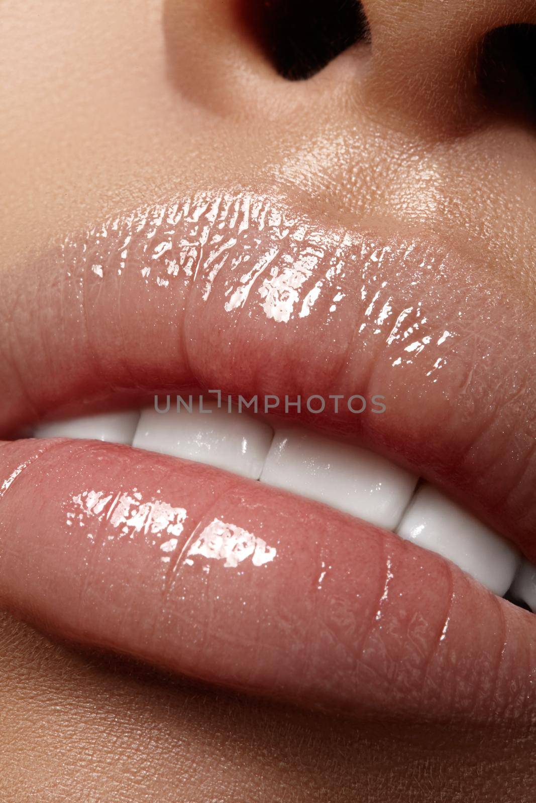 Moisturizing lip balm, lipstick. Close-up of a beautiful sexy wet lips. Nice full lips with gloss lip makeup. Filler Injections, Plastic Surgery, Collagen and Treatments