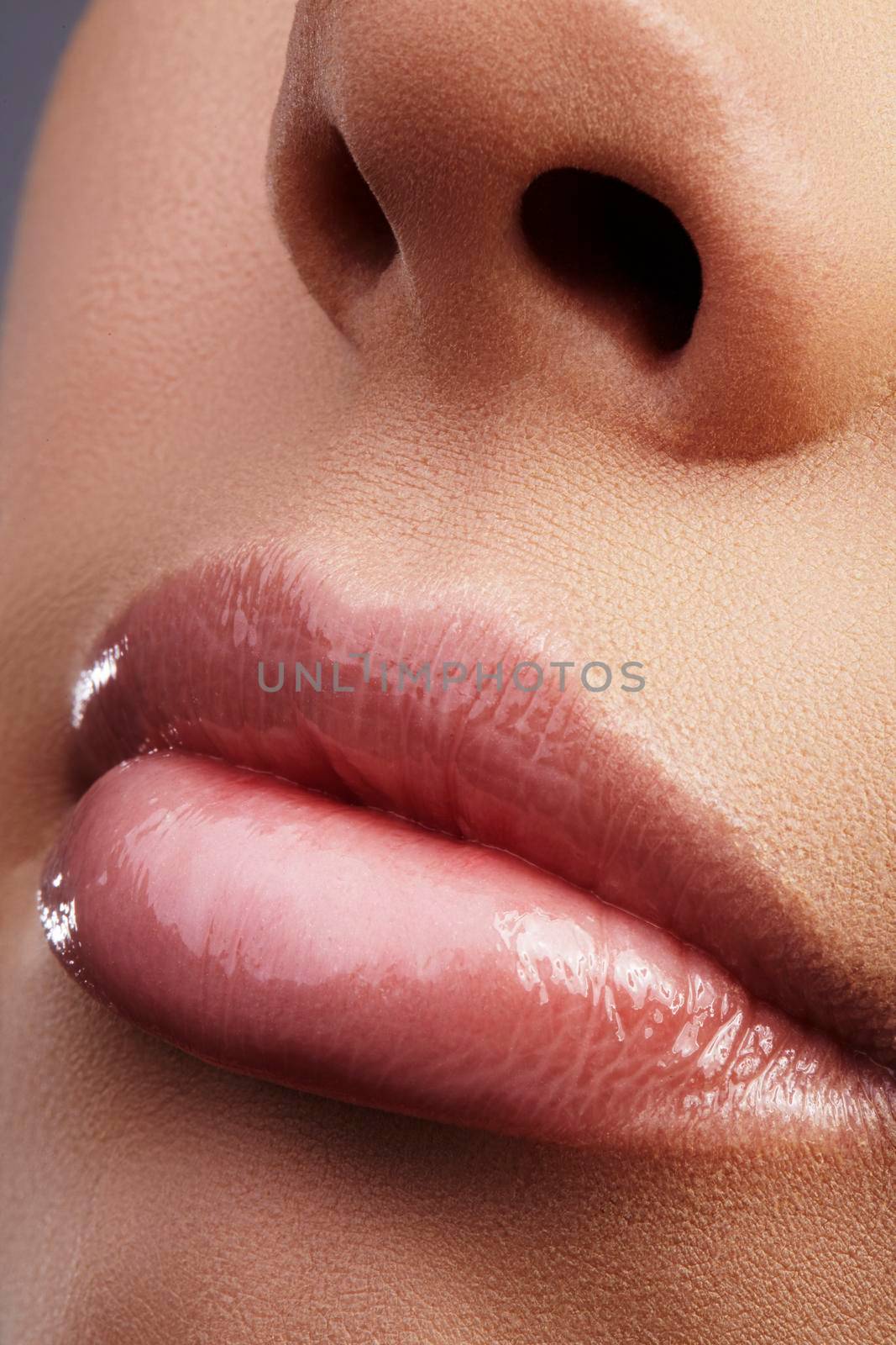 Face part. Beautiful female lips with natural makeup, clean skin. Macro shot of female lip, clean skin. Fresh kiss. Spa beauty cosmetics.