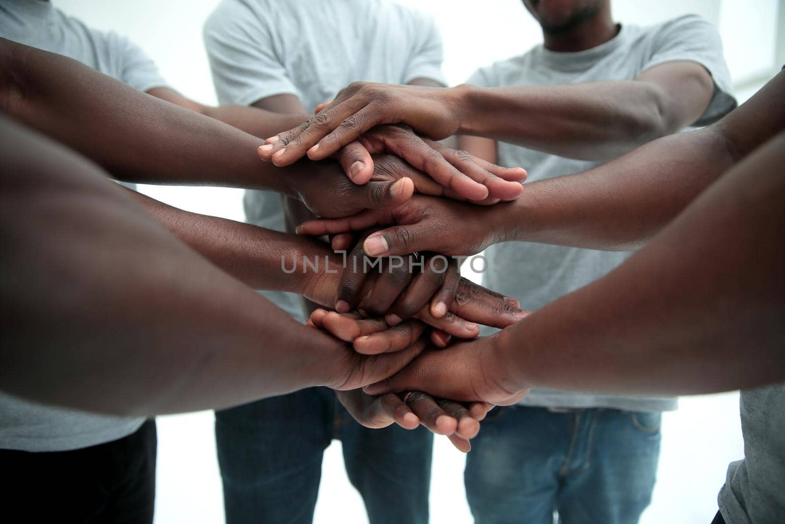 close up. a multi-ethnic group of friends showing their unity . isolated on white