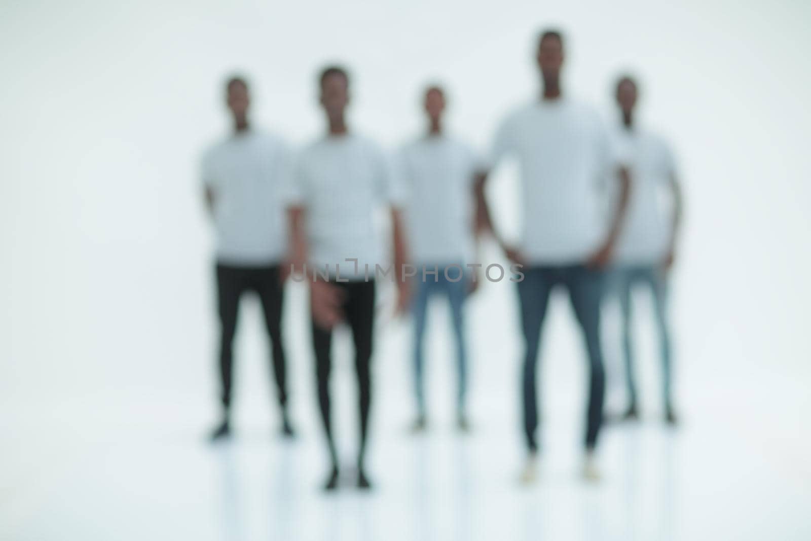 blurry image of a group of young men in white t-shirts . photo with copy space