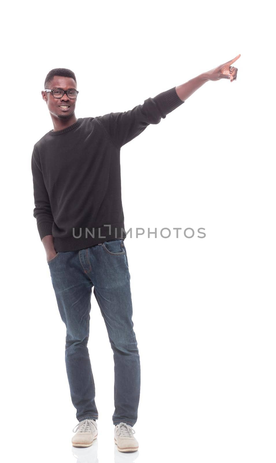 in full growth. young man in glasses pointing direction . isolated on white background