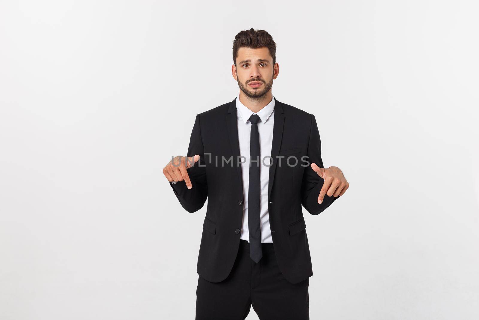 Business Concept: Portrait handsome young businessman point finger on side to empty copy space. Isolated over white background by Benzoix