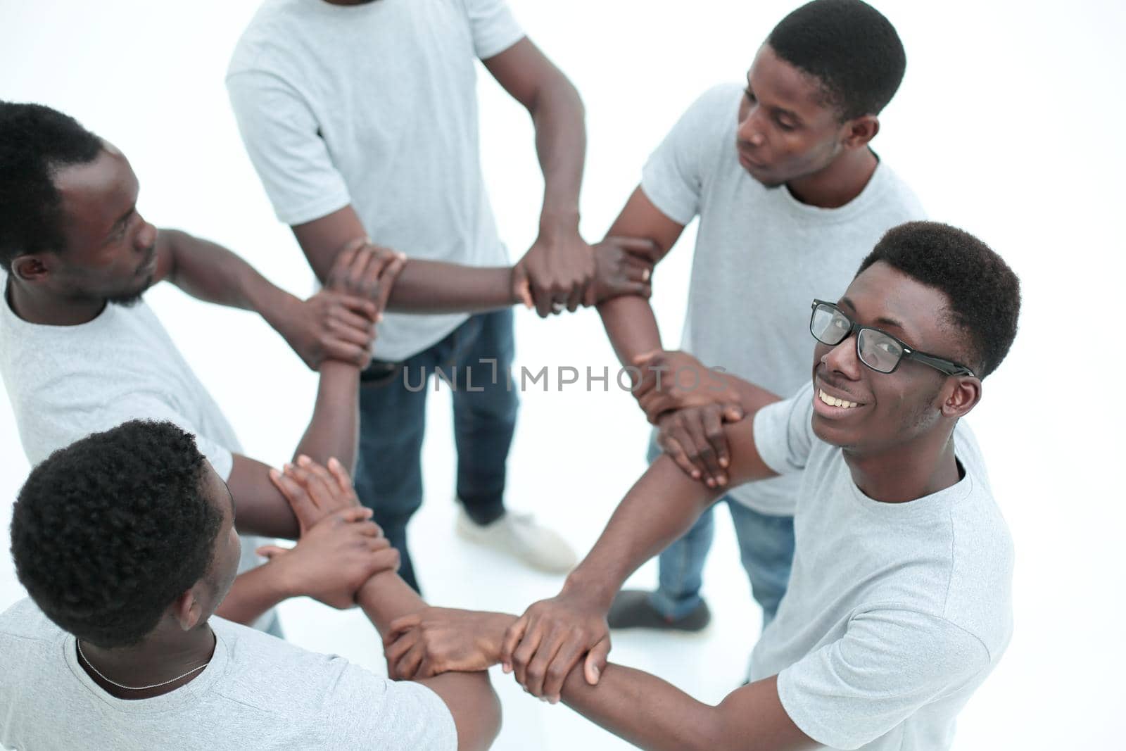 close up. group of diverse guys standing in a circle . isolated on white background