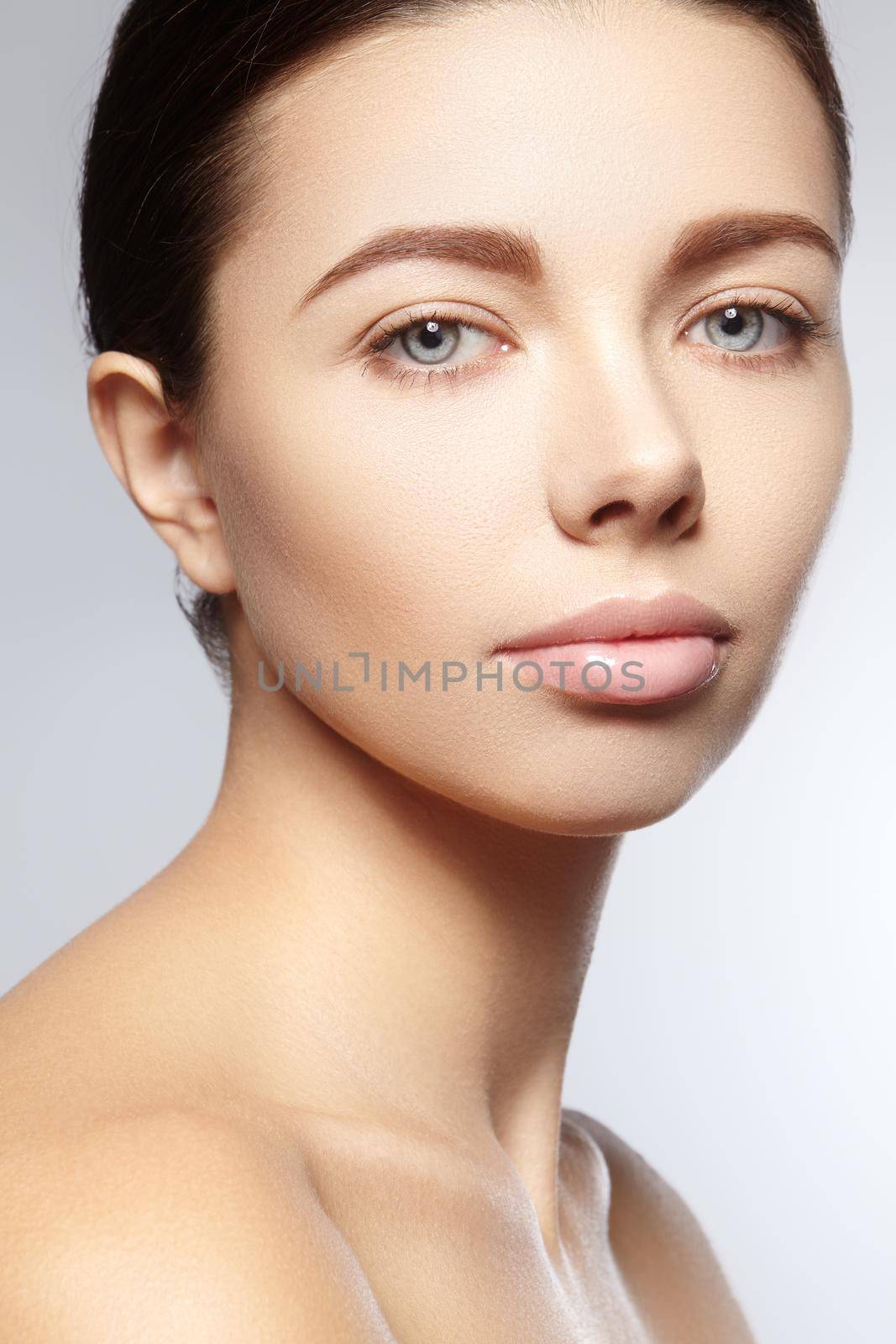 Beautiful young woman with perfect clean shiny skin, natural fashion makeup. Close-up woman, fresh spa look. Healthy beauty