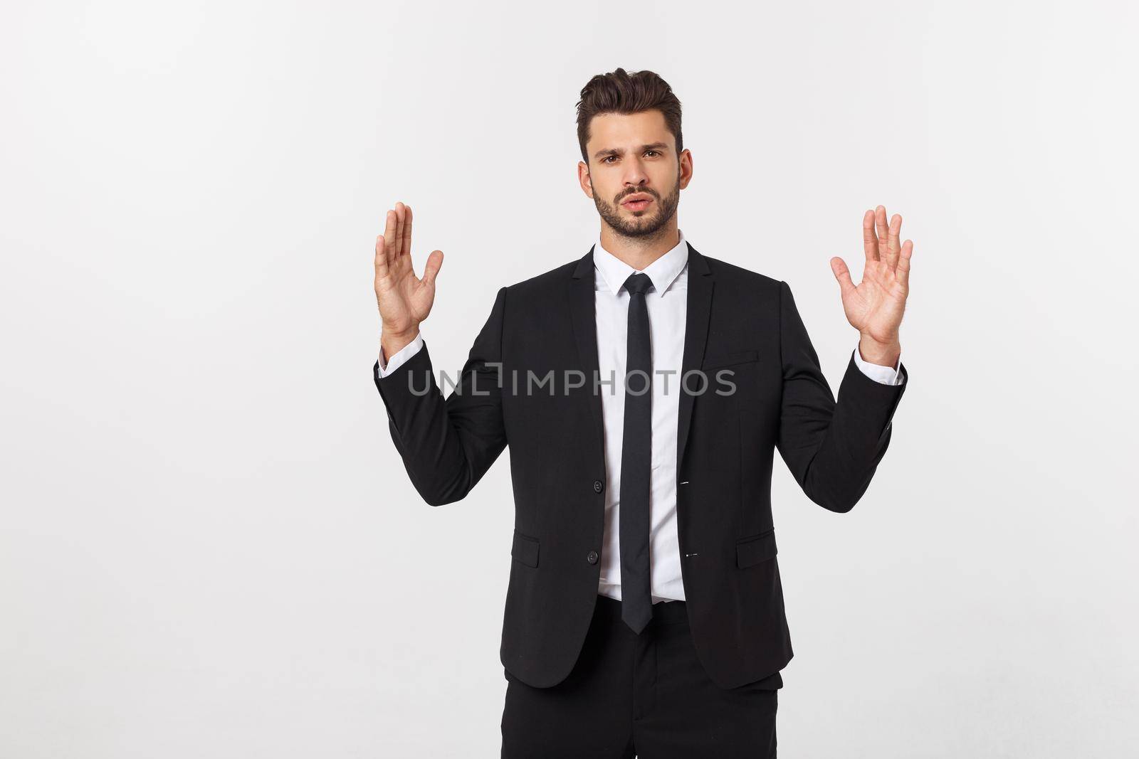 A man shows with his hands a large size on an isolated background by Benzoix