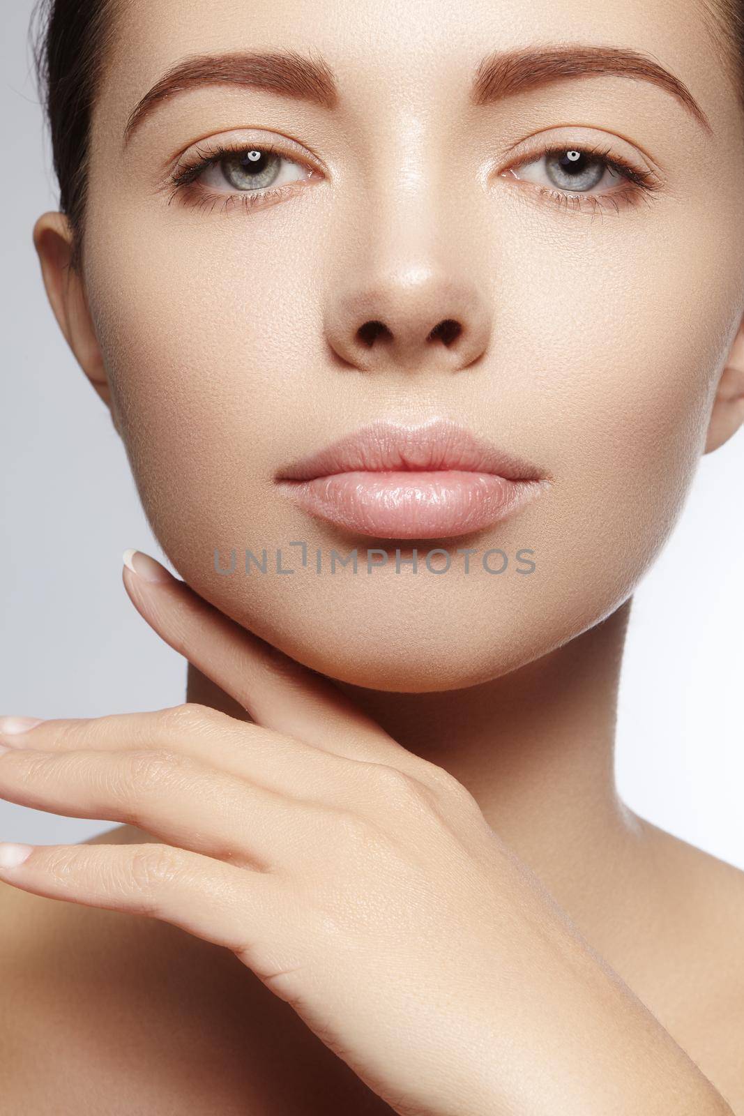 Beautiful young woman with perfect clean shiny skin, natural fashion makeup. Close-up woman, fresh spa look. Healthy beauty